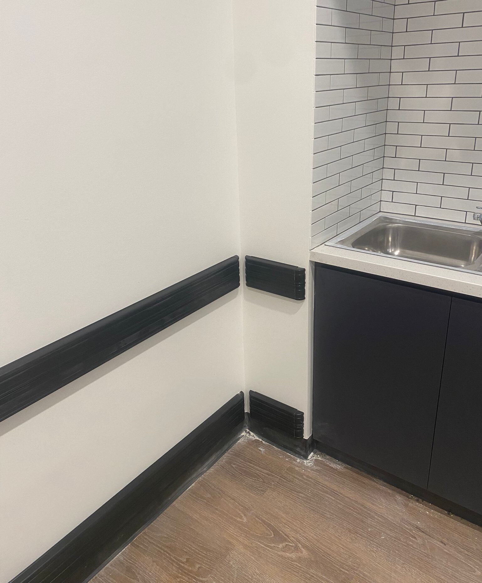 black bump rails and corner guards installed on walls