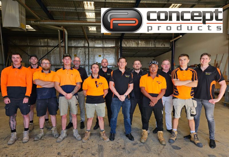 Group photo of the Concept Products team inside a workshop, with 14 staff members in branded uniforms standing under the company logo.