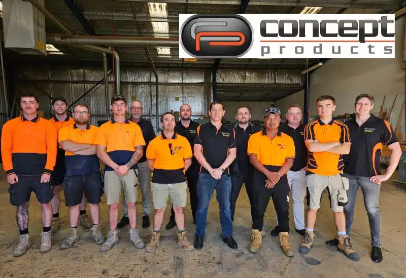 Group photo of the Concept Products team inside a workshop, with 14 staff members in branded uniforms standing under the company logo.